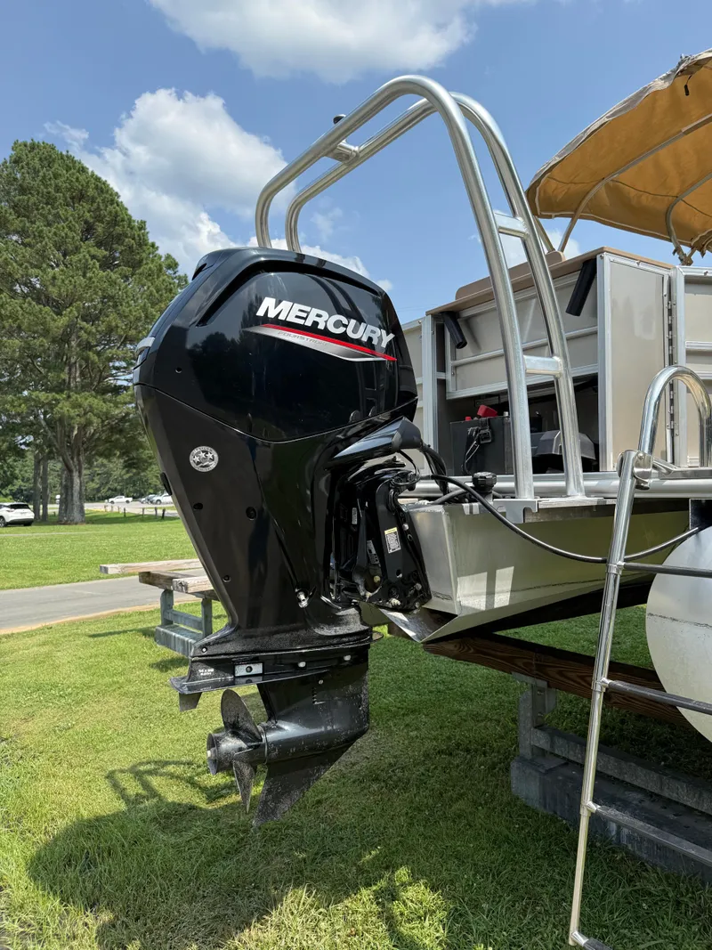 Slide: The Image of 2021 Sylvan Mirage 822 PARTY FISH with Mercury outboard motor on grassy area. - 10
