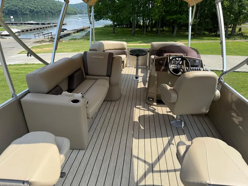 Slide: The Image of 2021 Sylvan Mirage 822 PARTY FISH pontoon boat interior with seating and steering console. - 2