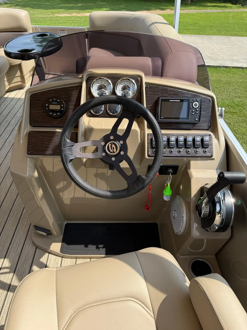 Slide: The Image of 2021 Sylvan Mirage 822 PARTY FISH boat dashboard with steering wheel and controls. - 3