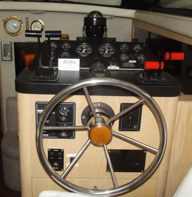 Slide: The Image of 1990 Silverton 37 Convertible helm with steering wheel and control panel. - 10