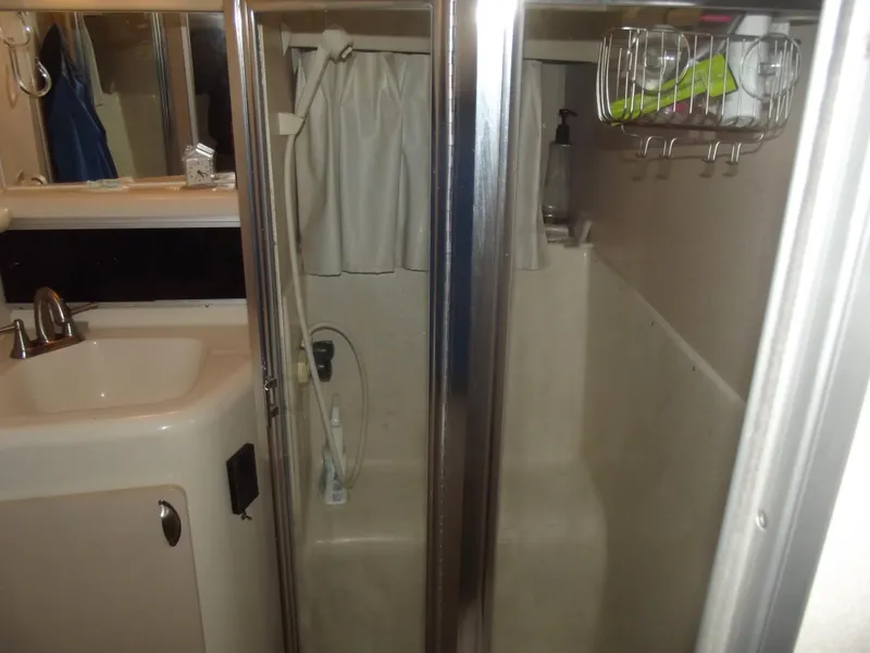 Slide: The Image of 1990 Silverton 37 Convertible bathroom with shower, sink, and storage rack. - 19