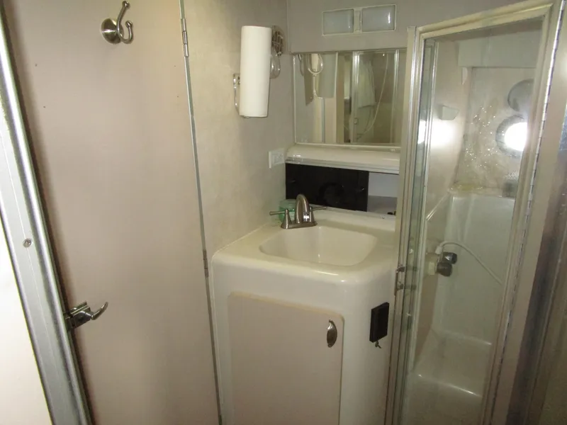 Slide: The Image of Bathroom interior of 1990 Silverton 37 Convertible yacht with sink and shower. - 30