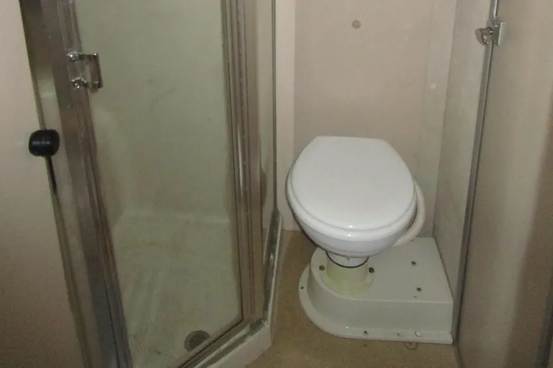 Slide: The Image of Bathroom with shower and toilet in 1990 Silverton 37 Convertible boat. - 31
