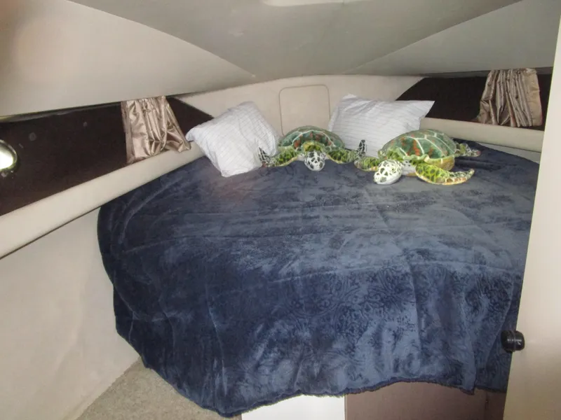 Slide: The Image of Cozy cabin interior of 1990 Silverton 37 Convertible with plush bedding and turtle decor. - 32