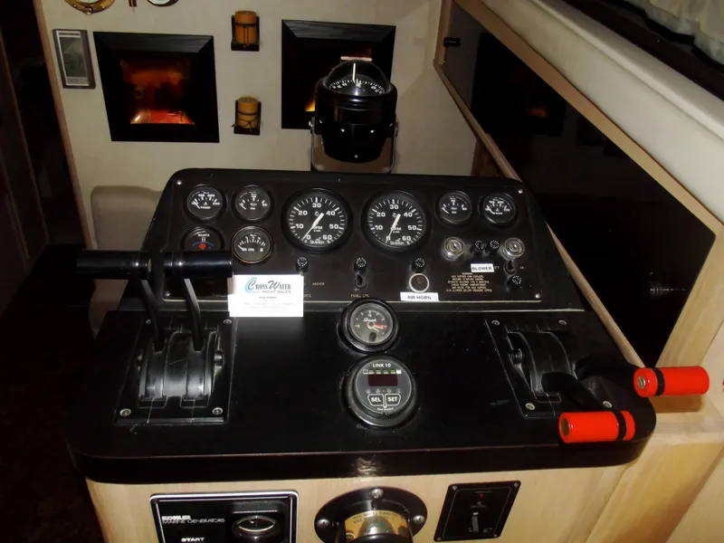 Slide: The Image of 1990 Silverton 37 Convertible boat dashboard with gauges and controls. - 8