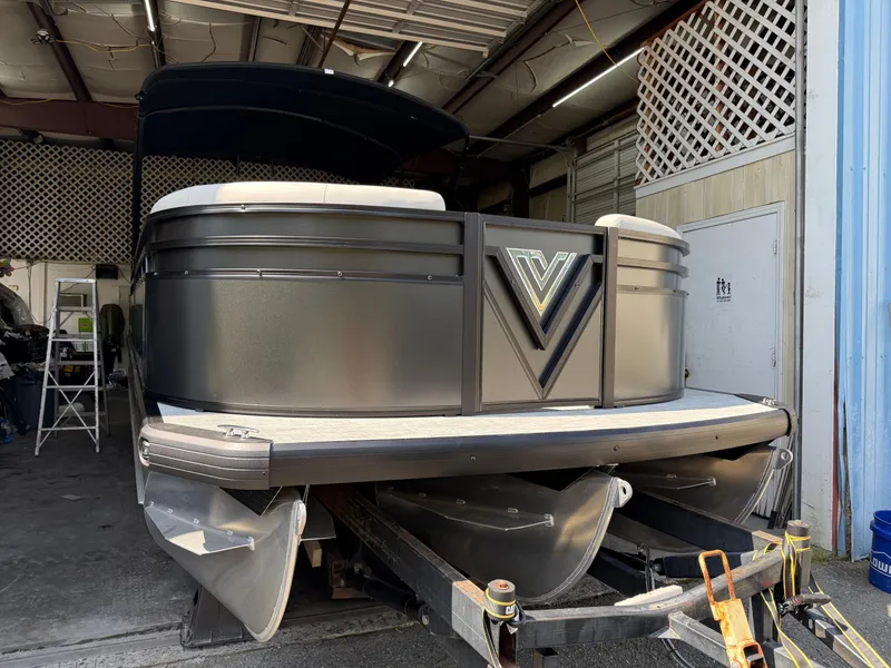 Slide: The Image of 2025 Viaggio Lago V-U pontoon boat in a garage, showcasing sleek design and modern features. - 8