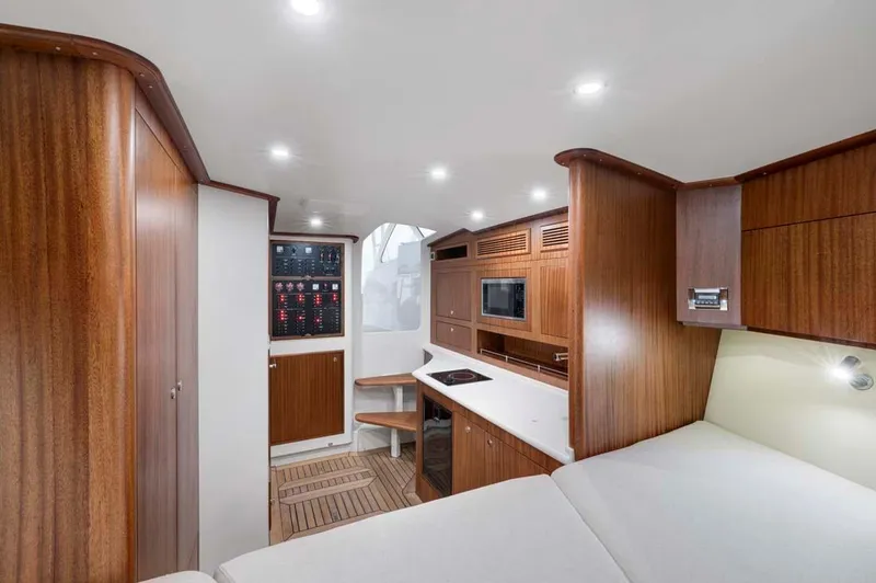 Slide: The Image of 2025 Vicem Express yacht interior with modern wood finish and compact kitchen area. - 4