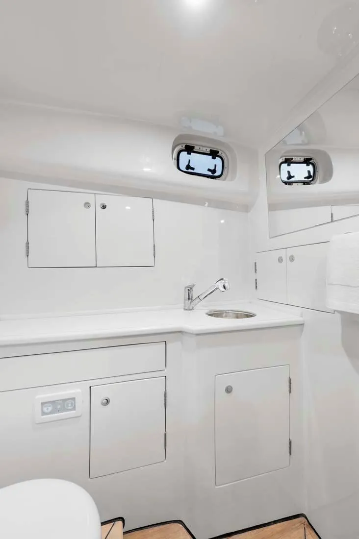 Slide: The Image of 2025 Vicem Express yacht bathroom with sleek white cabinetry and modern fixtures. - 6