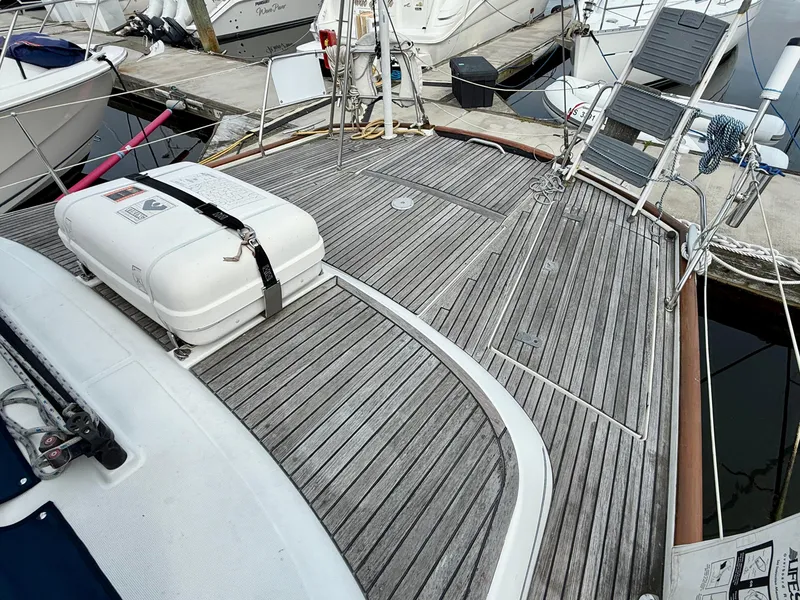 Slide: The Image of Deck of 2003 Beneteau Oceanis 42CC sailboat with wooden finish and safety equipment. - 13