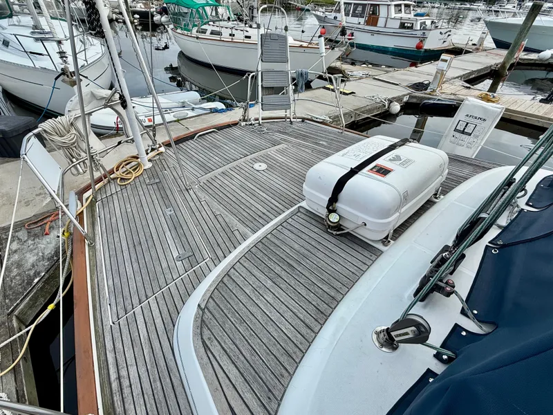 Slide: The Image of 2003 Beneteau Oceanis 42CC sailboat deck with lifeboat, docked in marina. - 14