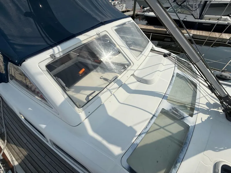 Slide: The Image of 2003 Beneteau Oceanis 42CC sailboat deck with blue canopy and clear windows. - 15