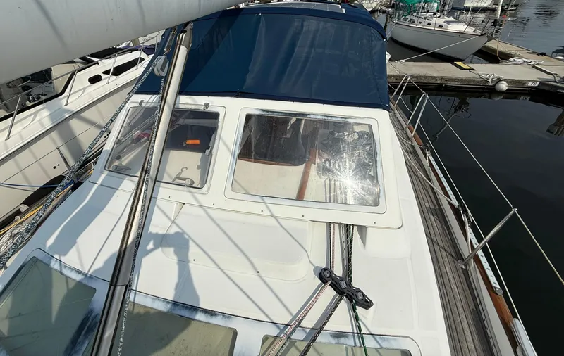 Slide: The Image of 2003 Beneteau Oceanis 42CC sailboat docked at marina, featuring deck and cabin details. - 16