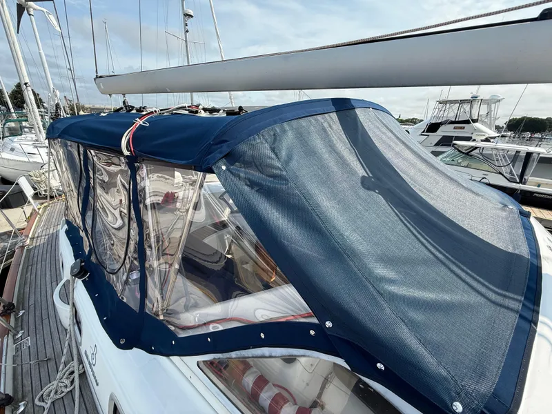 Slide: The Image of Beneteau Oceanis 42CC 2003 sailboat with blue canvas cover at marina. - 19