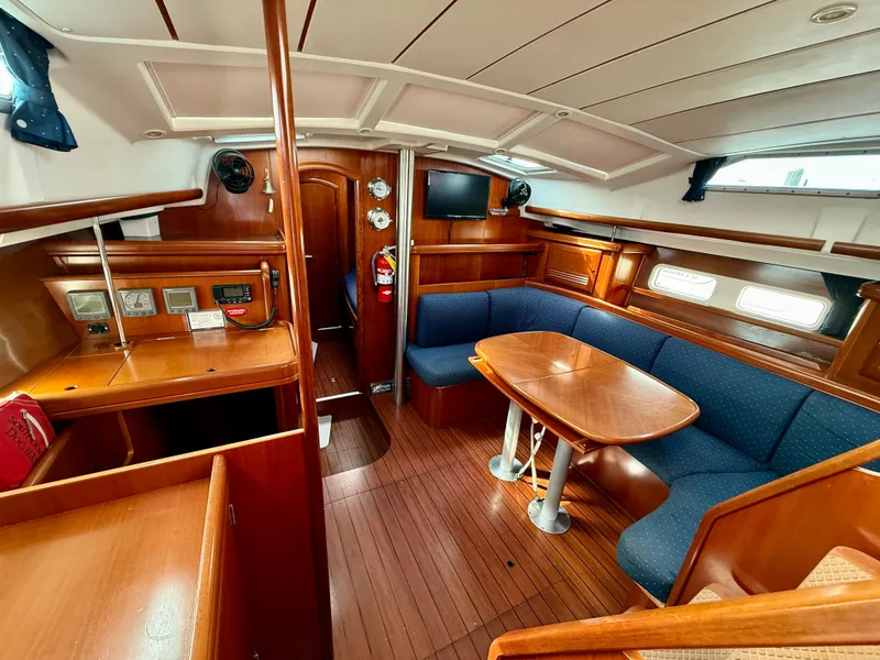 Slide: The Image of Interior of 2003 Beneteau Oceanis 42CC yacht with wooden finish and blue seating. - 23