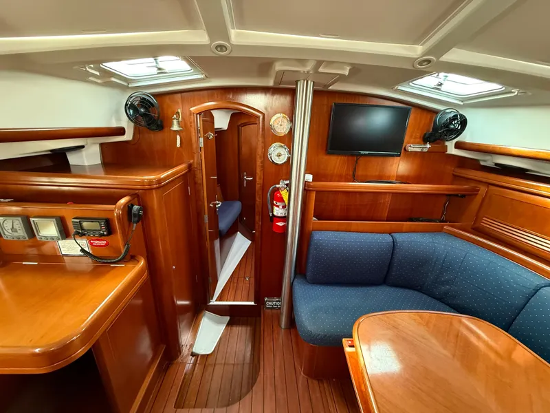 Slide: The Image of Interior of 2003 Beneteau Oceanis 42CC yacht with wood finish, seating, and navigation equipment. - 24