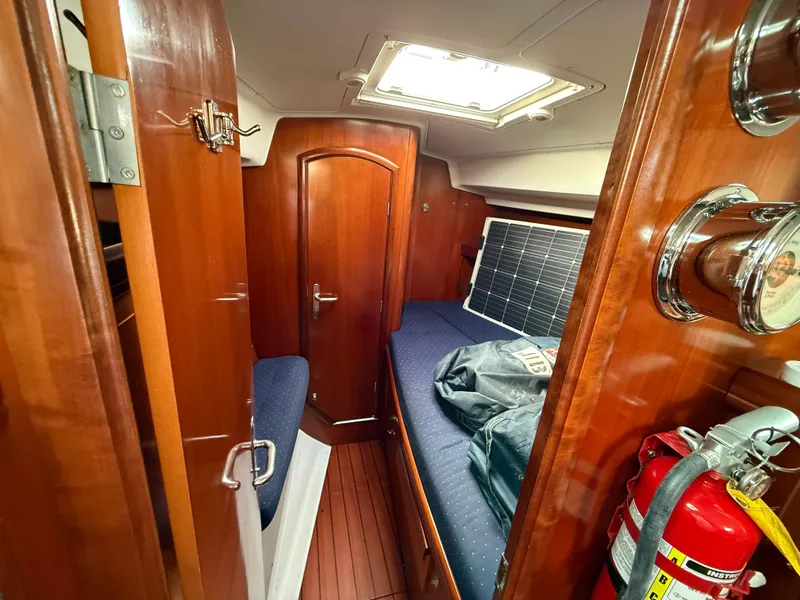 Slide: The Image of Interior cabin of 2003 Beneteau Oceanis 42CC sailboat with wood finish and fire extinguisher. - 25