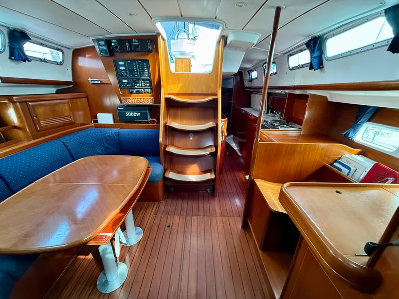 Slide: The Image of Interior of 2003 Beneteau Oceanis 42CC sailboat with wood finish and dining area. - 29