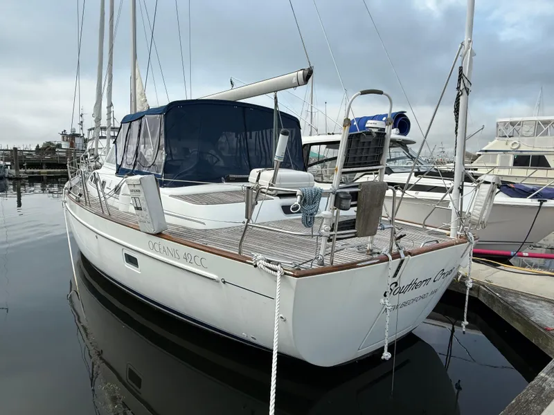 Slide: The Image of 2003 Beneteau Oceanis 42CC sailboat docked at marina, overcast sky. - 3