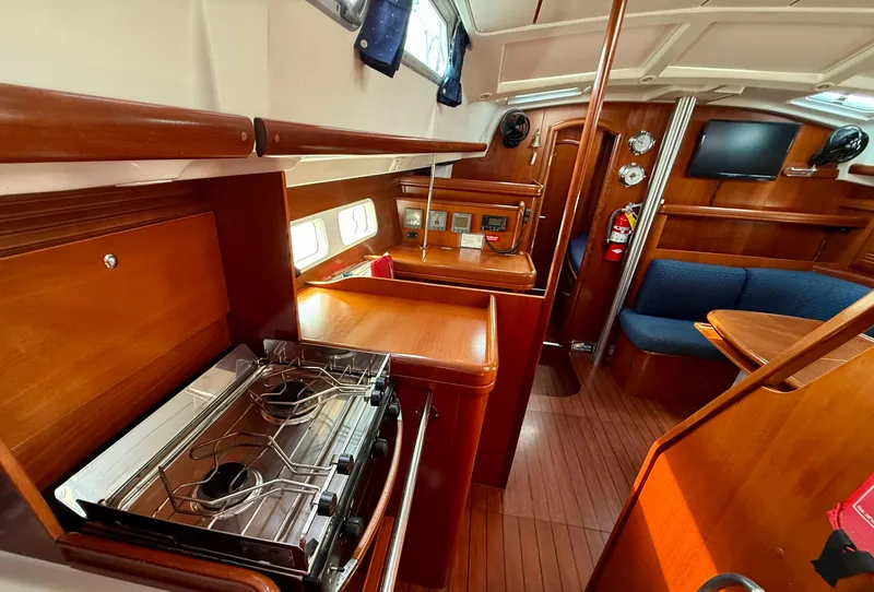 Slide: The Image of Interior of 2003 Beneteau Oceanis 42CC yacht with wood finish and modern amenities. - 34