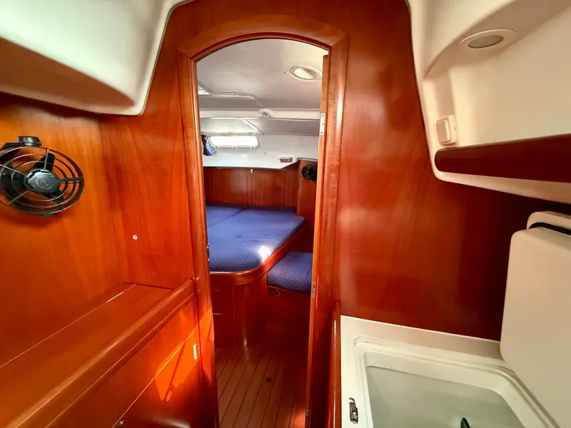 Slide: The Image of Interior of 2003 Beneteau Oceanis 42CC sailboat with wood finish and cozy cabin. - 39