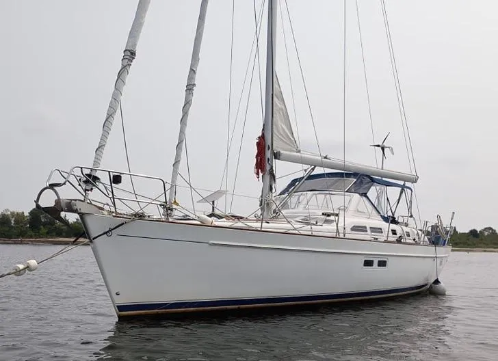 Slide: The Image of 2003 Beneteau Oceanis 42CC sailboat anchored on calm water. - 4
