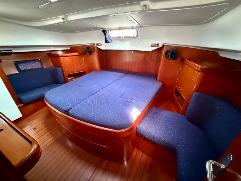 Slide: The Image of Luxurious cabin interior of 2003 Beneteau Oceanis 42CC with blue upholstery and wood finish. - 40
