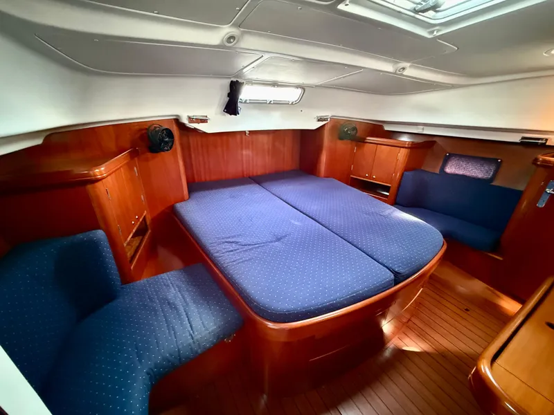 Slide: The Image of Interior of 2003 Beneteau Oceanis 42CC yacht with blue upholstery and wooden finish. - 41