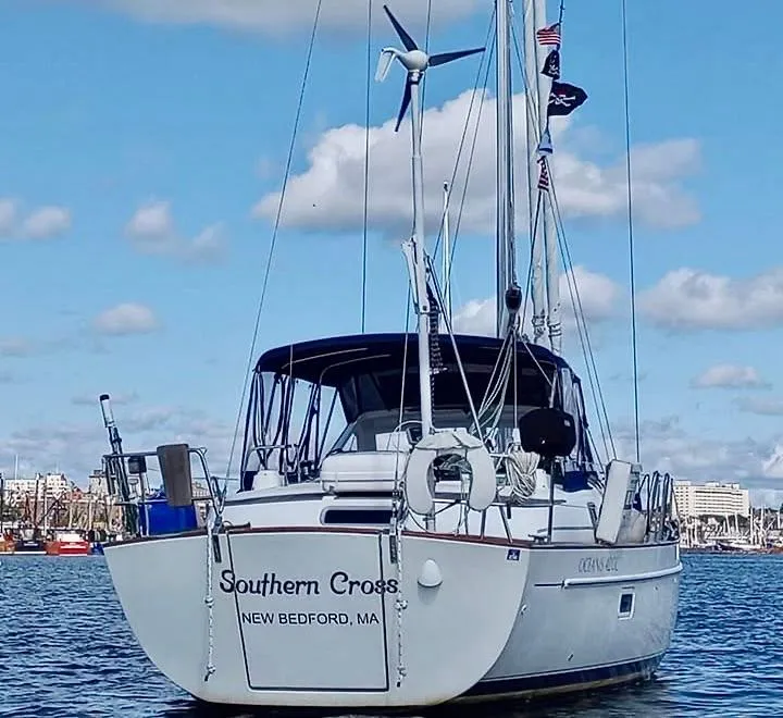 Slide: The Image of Beneteau Oceanis 42CC sailboat, 2003 model, anchored in a harbor under a blue sky. - 7