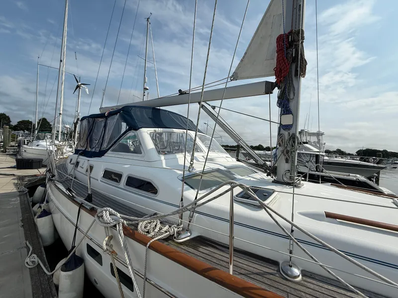 Slide: The Image of 2003 Beneteau Oceanis 42CC sailboat docked at marina under clear sky. - 8