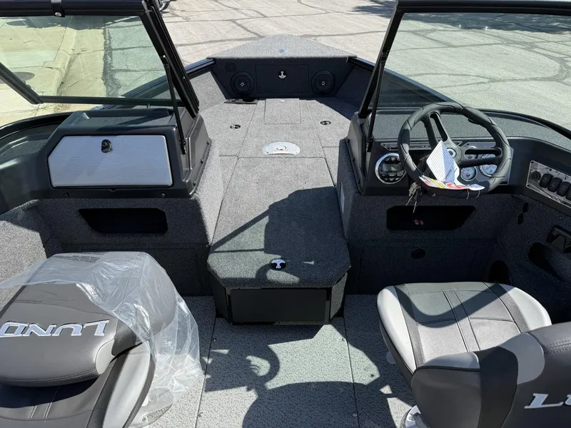 Slide: The Image of 2025 Lund 1775 Impact XS boat interior with steering wheel and seating. - 3