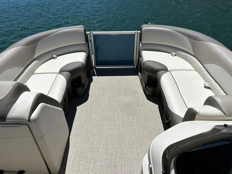 Slide: The Image of 2022 Avalon 24 LSZ VRB-3 pontoon boat interior with plush seating on a sunny day. - 18