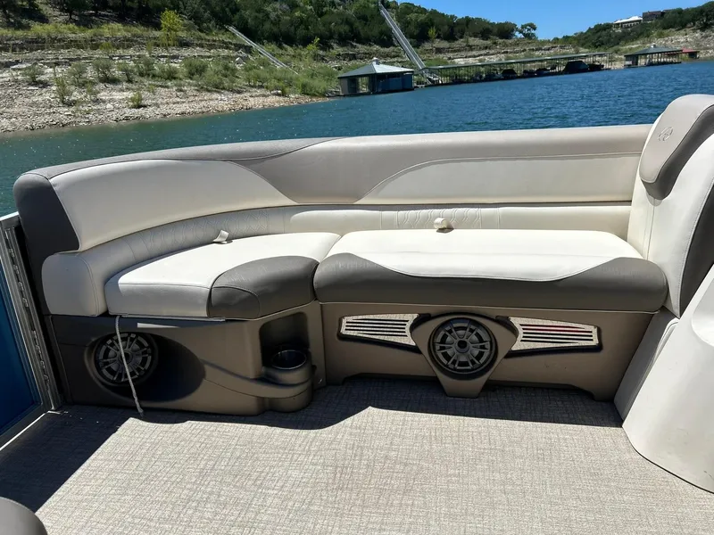 Slide: The Image of 2022 Avalon 24 LSZ VRB-3 pontoon boat interior with cushioned seating and speaker system. - 20