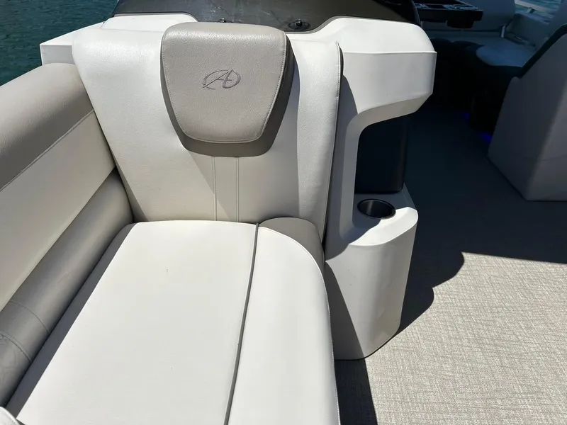 Slide: The Image of 2022 Avalon 24 LSZ VRB-3 boat interior with white leather seating and cup holder. - 21