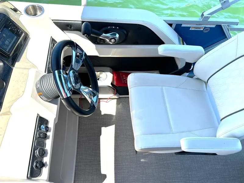 Slide: The Image of Captain's seat and controls of 2022 Avalon 24 LSZ VRB-3 pontoon boat. - 25