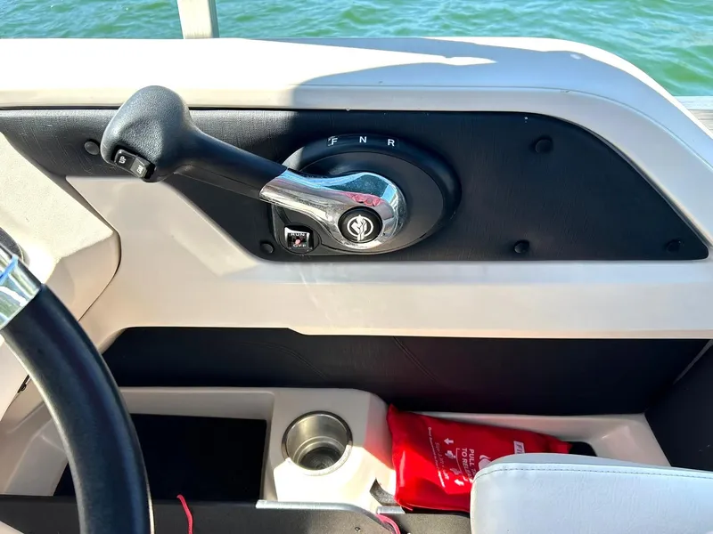 Slide: The Image of Throttle control of 2022 Avalon 24 LSZ VRB-3 boat, with cup holder and safety gear. - 28