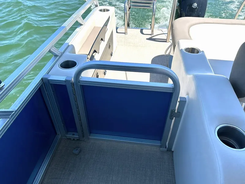 Slide: The Image of 2022 Avalon 24 LSZ VRB-3 boat interior with seating and cup holders on a sunny day. - 39