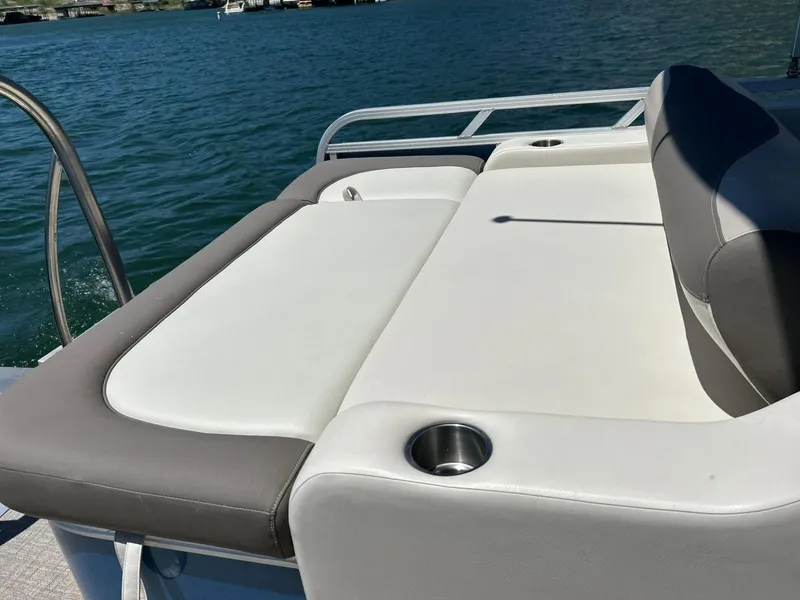 Slide: The Image of 2022 Avalon 24 LSZ VRB-3 boat with comfortable seating and cup holders on a sunny day. - 41