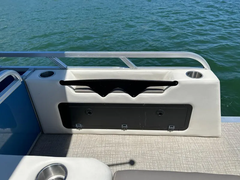 Slide: The Image of 2022 Avalon 24 LSZ VRB-3 boat interior with cup holders and railing, overlooking water. - 44