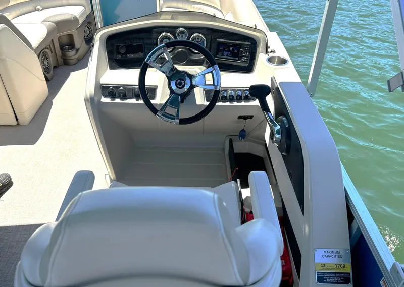 Slide: The Image of Cockpit of 2022 Avalon 24 LSZ VRB-3 pontoon boat with steering wheel and controls. - 6