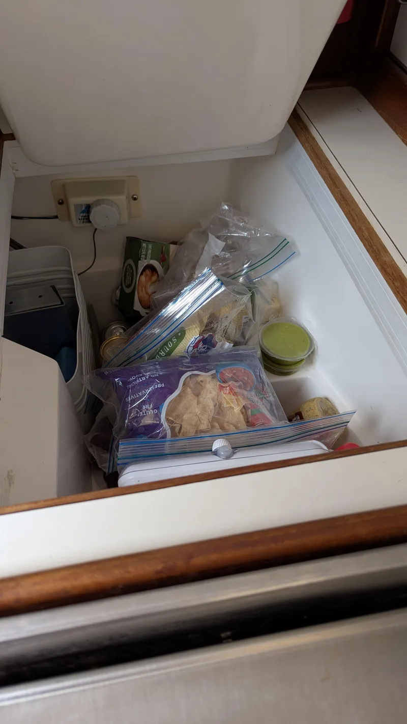Slide: The Image of Storage compartment with food items in a 1988 Catalina 30 MkII boat. - 24