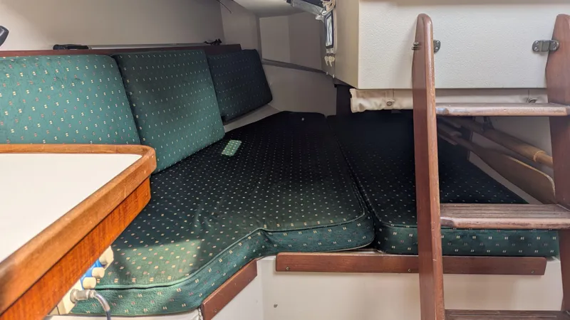 Slide: The Image of Interior cabin of 1988 Catalina 30 MkII sailboat with green cushioned seating. - 27
