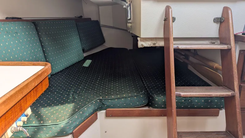 Slide: The Image of Interior cabin of a 1988 Catalina 30 MkII sailboat with green cushioned seating. - 28