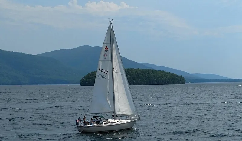 Slide: The Image of Sailboat Catalina 30 MkII 1988 on a scenic lake with mountains in the background. - 37