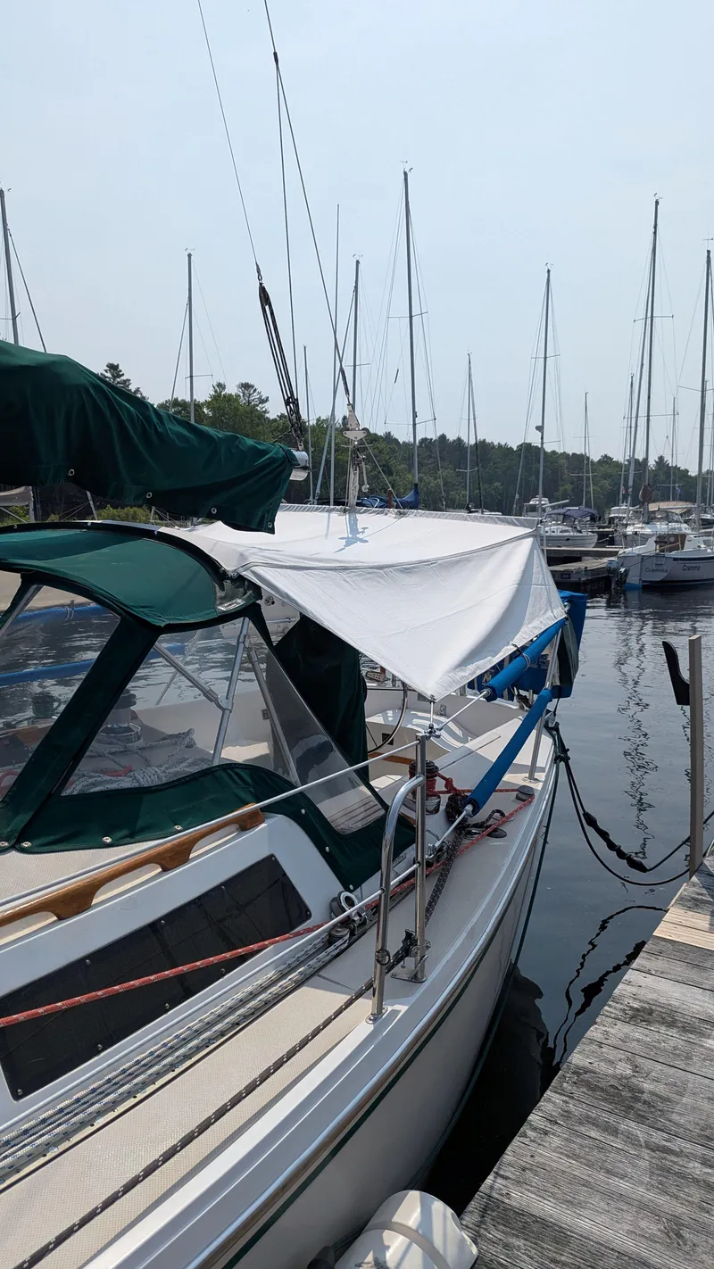 Slide: The Image of 1988 Catalina 30 MkII sailboat docked at a marina with other sailboats. - 4