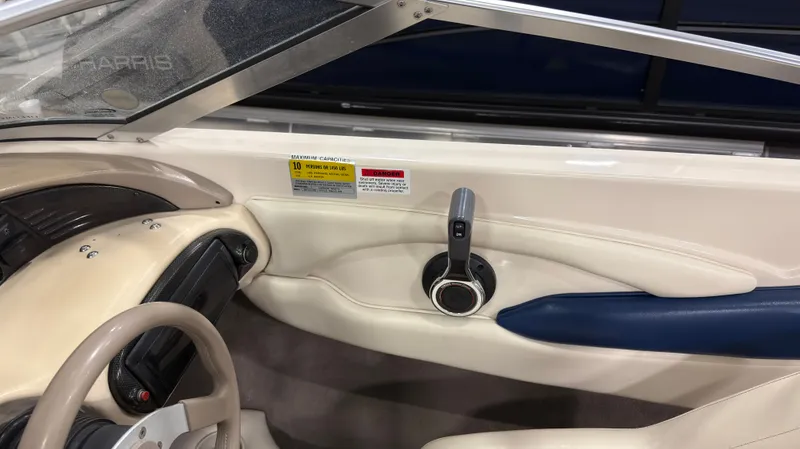 Slide: The Image of Interior of a 2002 Larson 210 SEI boat with steering console. - 10