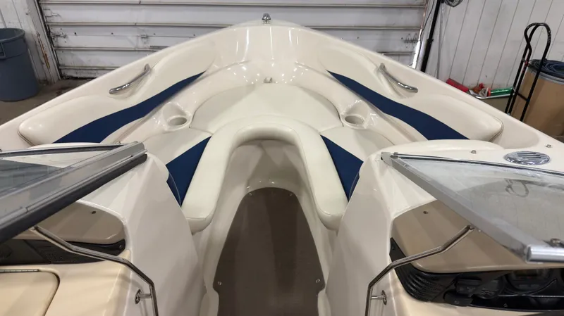 Slide: The Image of Interior view of a 2002 Larson 210 SEI boat with blue accents. - 11