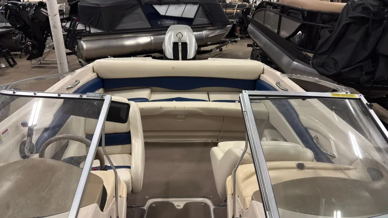 Slide: The Image of Interior of a 2002 Larson 210 SEI boat, beige and blue. - 12