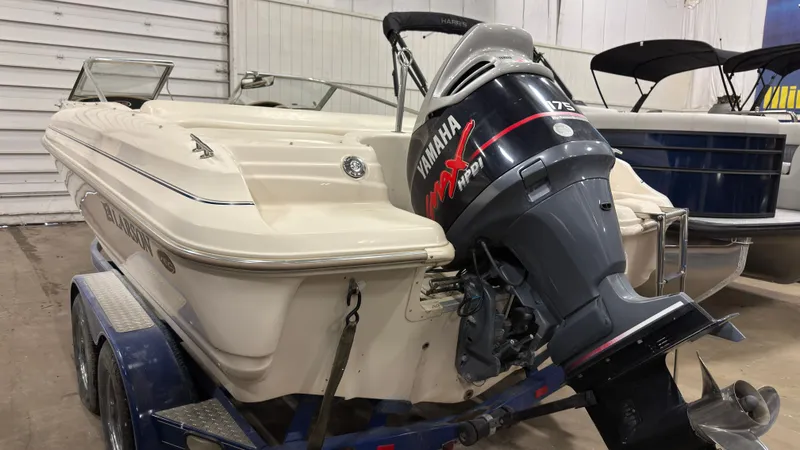 Slide: The Image of 2002 Larson 210 SEI boat with Yamaha outboard motor. - 2