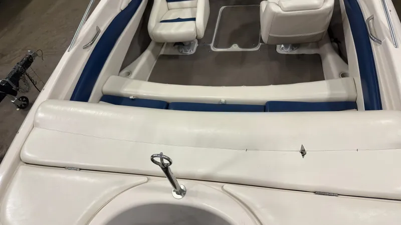 Slide: The Image of Interior of a 2002 Larson 210 SEI boat with white and blue seating. - 4