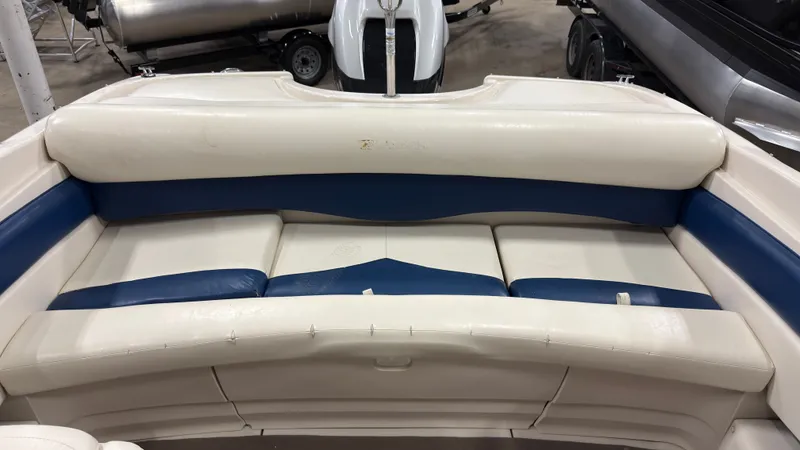 Slide: The Image of Interior of a 2002 Larson 210 SEI boat with blue and white seating. - 6